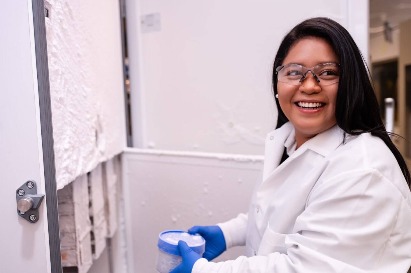 Scientist retrieving samples from a laboratory freezer.